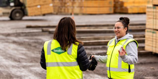 Two team members talking in the yard